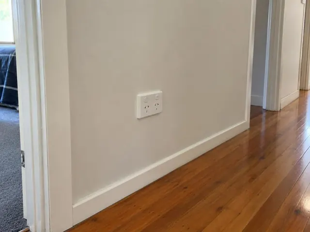 White double power point on a painted hallway wall above timber floor in Chittaway Bay